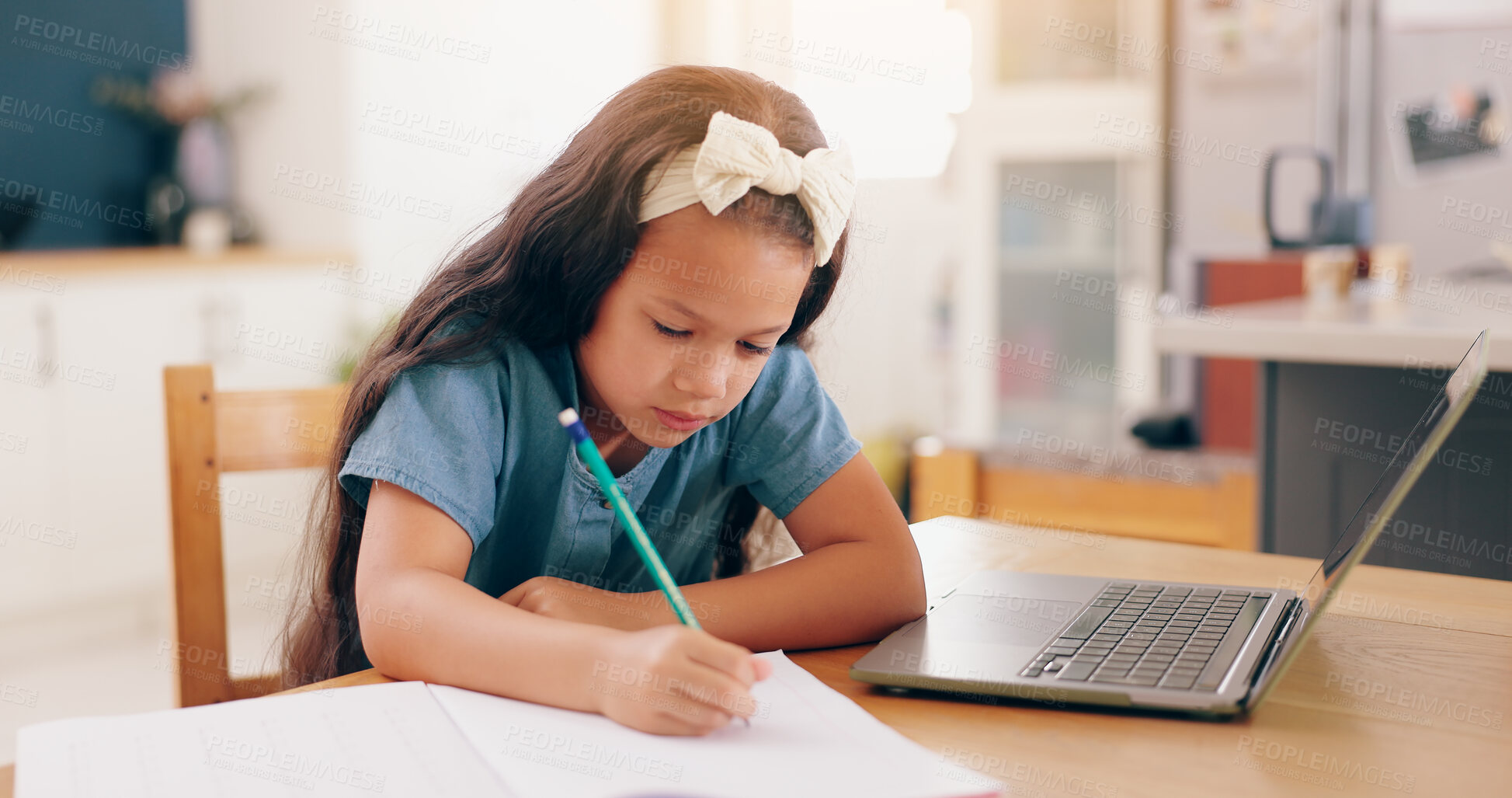 Buy stock photo Girl, learning and writing with pencil, homework and book for development, knowledge and thinking at desk. Child, student and notebook by laptop for education, problem solving or notes in family home