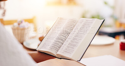 Person, bible book and point with hands, reading or studying for praise, worship or faith in home. Knowledge, closeup and information with religion, learning or spiritual guide for connection to God