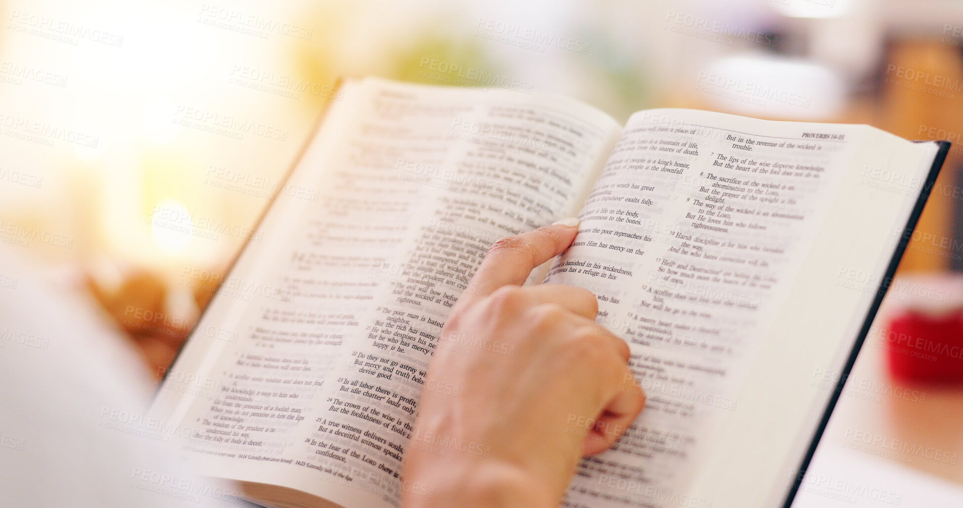 Buy stock photo Person, bible book and closeup with hands, reading or studying for praise, worship or faith in home. Knowledge, information or religion with history, learning or spiritual guide for connection to God