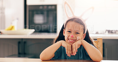 Buy stock photo Girl, child and bunny ears for portrait in home to smile for culture, holiday or festive celebration. Kid, face paint and art for rabbit, Easter and happy for creativity, play or mask in family house