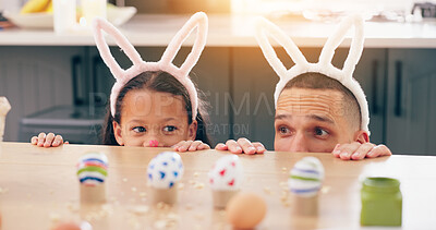 Child, father and easter with eggs, happy or thinking at table for game, festive holiday or celebration. Dad, kid and bunny ears for rabbit costume, ideas or playful for love, bonding and family home