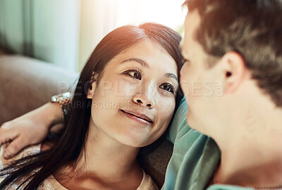 Buy stock photo Cropped shot of a happy young couple relaxing on their couch at