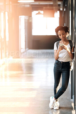 Buy stock photo Shot of a young woman using a mobile phone at university