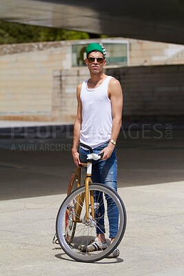 Buy stock photo Street wear, fashion and man with a bicycle in a city for eco friendly or sustainable transport on urban background. Style, attitude and male person posing with a bike for cycling, commute or travel