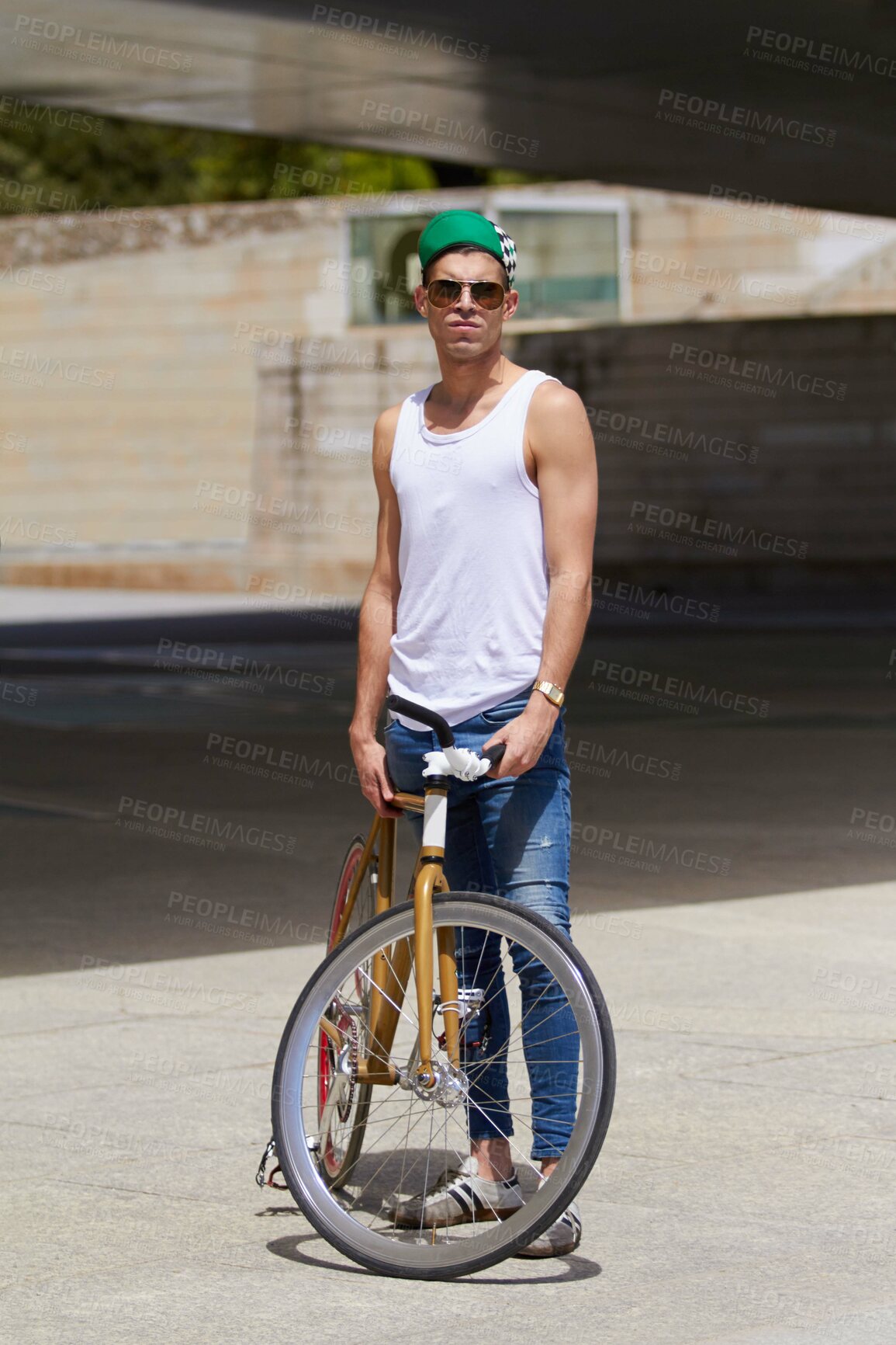 Buy stock photo Street wear, fashion and man with a bicycle in a city for eco friendly or sustainable transport on urban background. Style, attitude and male person posing with a bike for cycling, commute or travel