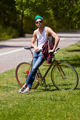 Buy stock photo Student man, fashion and bicycle at campus with sunglasses, confident and sustainable travel in summer. Young male person, gen z guy and retro bike in sunshine for eco friendly transport at college