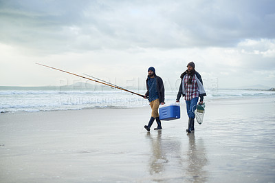 Buy stock photo Winter, fishing and men walking on beach together with cooler, tackle box and holiday conversation. Ocean, fisherman or friends with rods, bait and tools in nature on morning vacation with cloudy sky