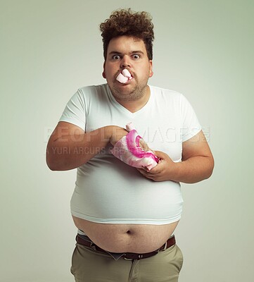 Buy stock photo Shot of an overweight man with marshmallows shoved in his mouth