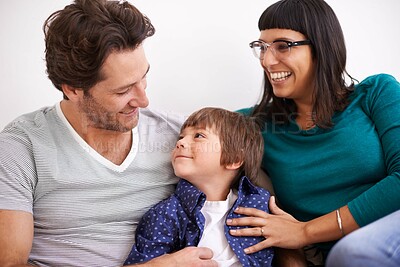 Buy stock photo Family, happiness and parents with child on couch in living room, together with security and comfort for love. Bonding, care and people relax at home with smile on face, trust and support in life