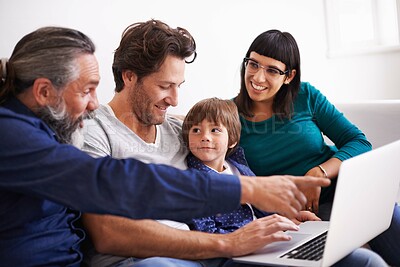 Buy stock photo Family, laptop and learning or streaming on sofa, smile and bonding in living room. Video call, internet and chat with grandfather pointing, parents and young boy for communication online in home