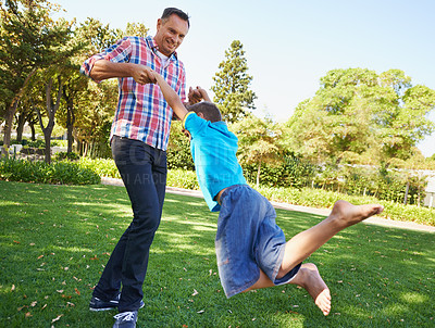 Father, child and spinning fun or outdoor bonding for recreation connection or playing, holiday or summer. Man, son and happiness on park field for vacation together in Australia, joy or carefree