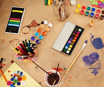 Buy stock photo Paint, color and stationery with supplies for drawing, sketching or arts and crafts on table above. Top view of empty room, interior or equipment of artistic tools for creativity and imagination
