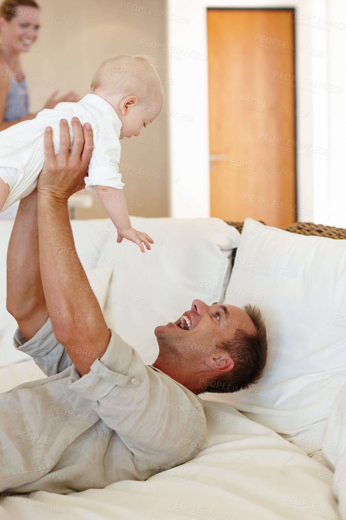 Buy stock photo Funny, father and play with baby on sofa in home for love, care or family bonding together. Happy dad, kid and cute infant in living room for connection of mother, smile and parents laugh with child