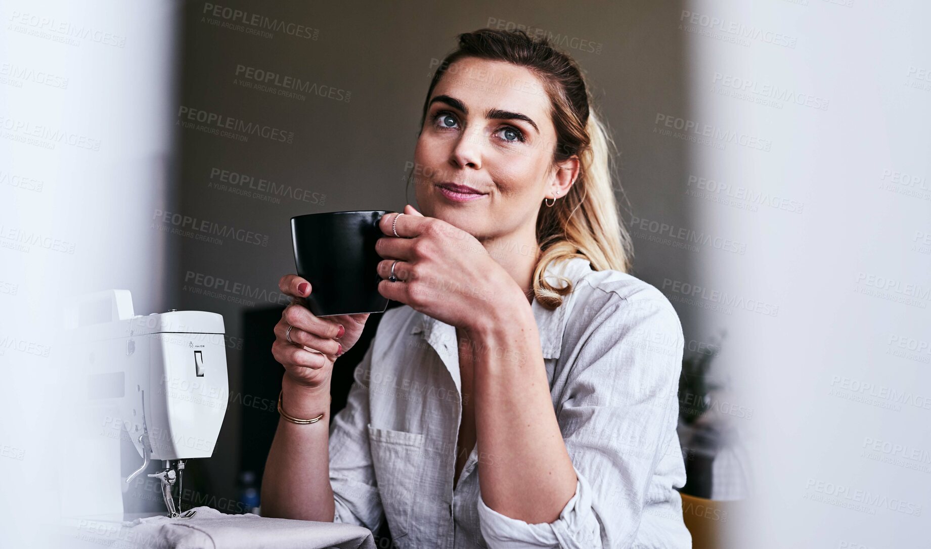 Buy stock photo Cropped shot of a fashion designer having coffee at her desk