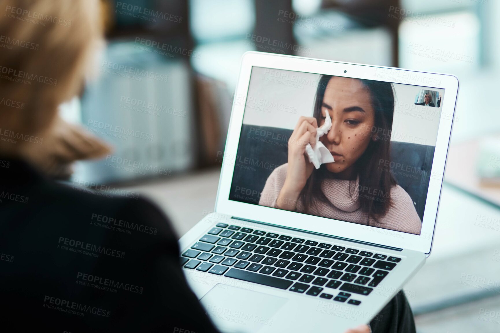 Buy stock photo Shot of a young woman having a counselling session with a psychologist using a video conferencing tool