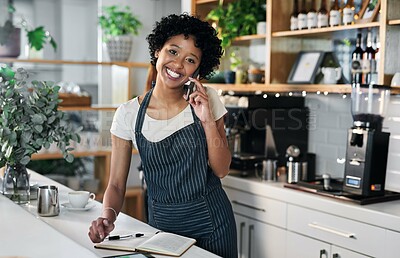 Buy stock photo Portrait of a young woman talking on a cellphone while working in a cafe