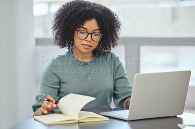 Buy stock photo Shot of an attractive young businesswoman sitting alone in her office and working