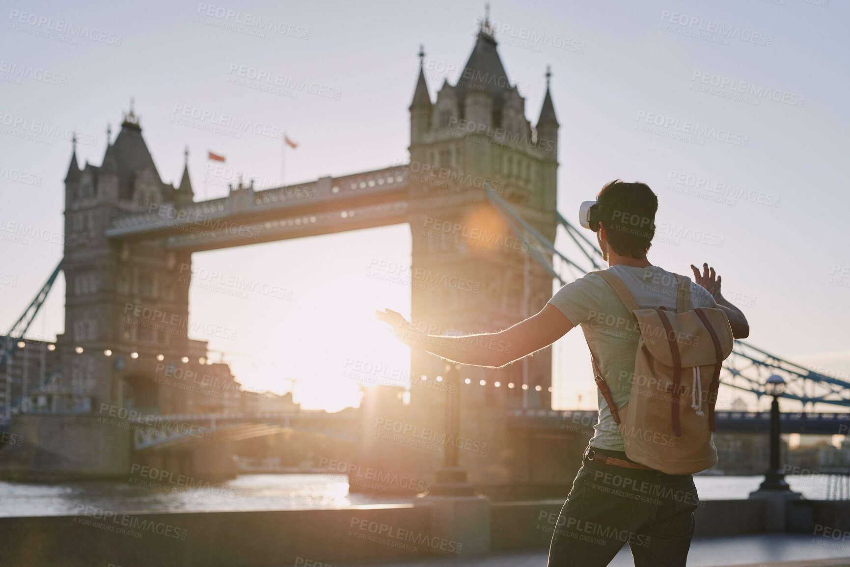 Buy stock photo VR, gaming and man on a holiday in London for travel, ai experience and futuristic metaverse in the city. Europe, digital fantasy and gamer with 3d virtual reality glasses at a bridge in England