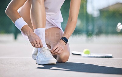 Buy stock photo Female tennis player foot and hands tying shoelaces before game match on outdoor sports court. Active, sporty woman preparing for training for fun, summer exercise and healthy, wellness lifestyle.