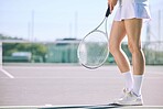 Legs of a female tennis player practicing or training for a match outdoors on the court on a sunny day. Active, fit and athletic female athlete or sportswoman playing a sport for a club 