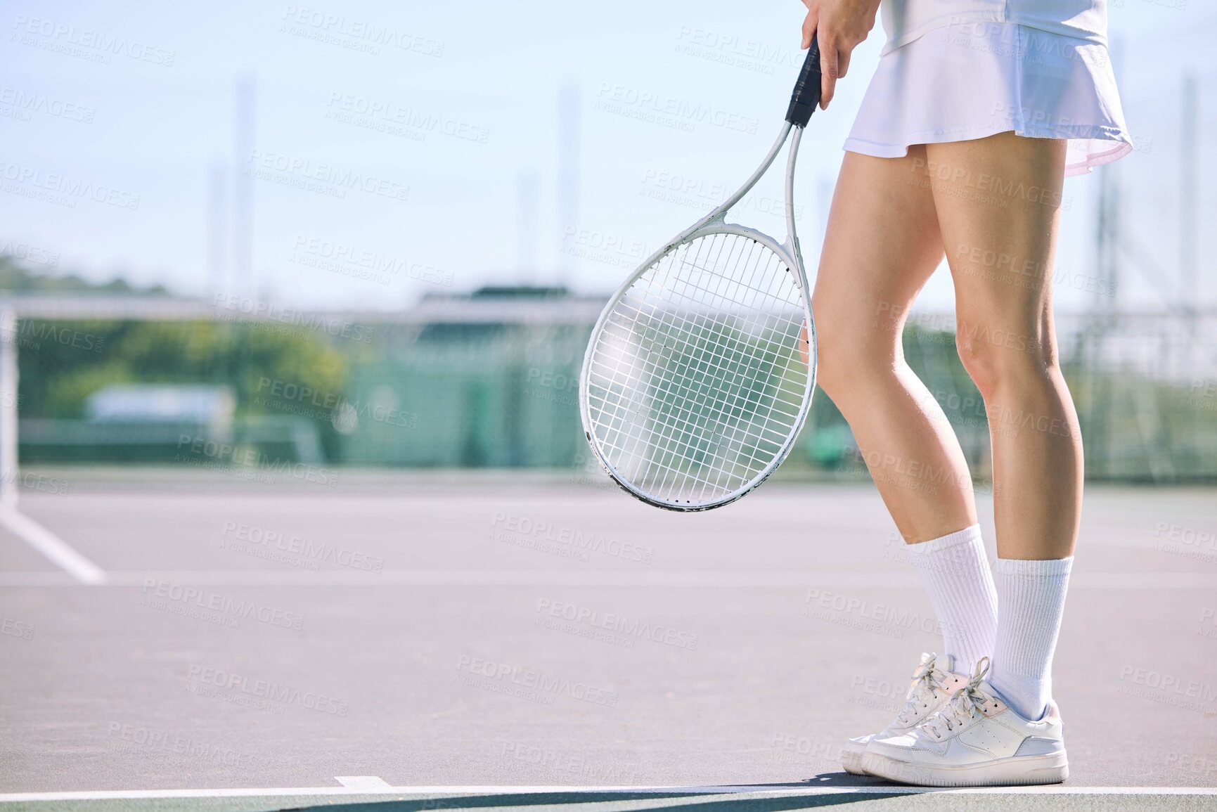 Buy stock photo Legs of a female tennis player practicing or training for a match outdoors on the court on a sunny day. Active, fit and athletic female athlete or sportswoman playing a sport for a club 