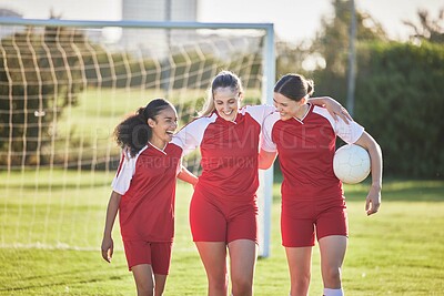 Buy stock photo Fun female football players or friends in sportswear hugging, smiling and bonding together after practicing on a field. Young, sport and athletic soccer girls talking about good and exciting match