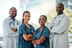Group of happy diverse doctors and nurses standing in a line with their arms crossed while working at a hospital. Content expert medical professionals at work together at a clinic