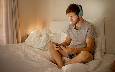 Buy stock photo Headphones, digital tablet and in bed watching online movies, videos or series at night in house bedroom. Man on entertainment news or internet film streaming app or  website on home 5g wifi network