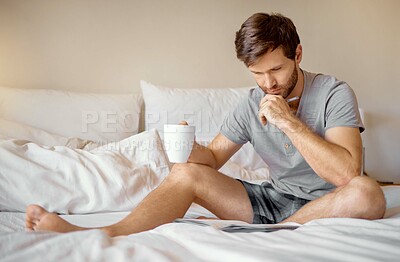 Buy stock photo Relax, bedroom and thinking man working on magazine puzzle game or quiz at airbnb or hotel room. Young male drinking coffee after waking up from sleep in the morning, and reading brochure book in bed
