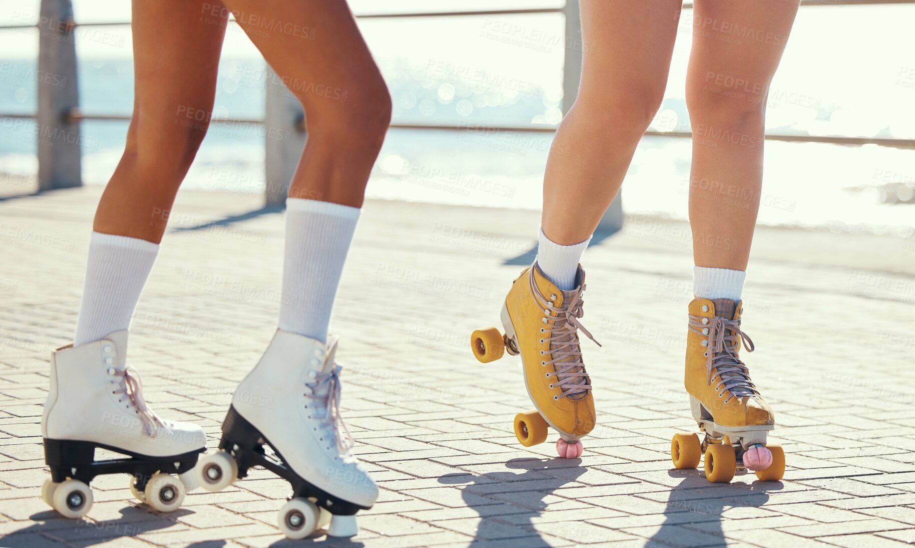 Buy stock photo Roller skates or fun friends on promenade for summer holiday activity or travel outdoor. Cool, trendy or funky women skating legs in quad skating or rollerblades with sunshine, beach and ground