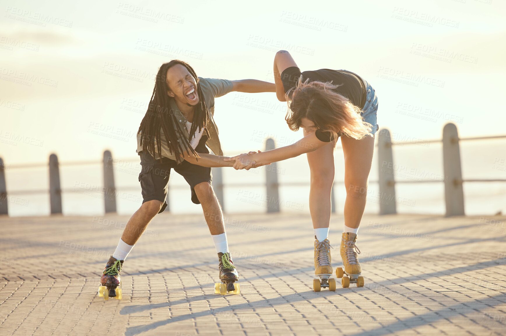 Buy stock photo Freedom, fun and happy couple laughing and roller skating outdoors together, positive, playful and cheerful. Excited interracial boyfriend and girlfriend being crazy while enjoying skate practice
