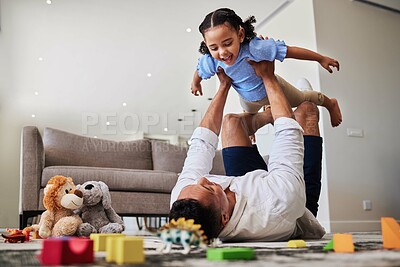 Buy stock photo Dad, lying and lifting with child, airplane or playing in living room for care, bonding and happy. Father, girl and floor with toys, game or plane with legs in house, lounge or apartment with love