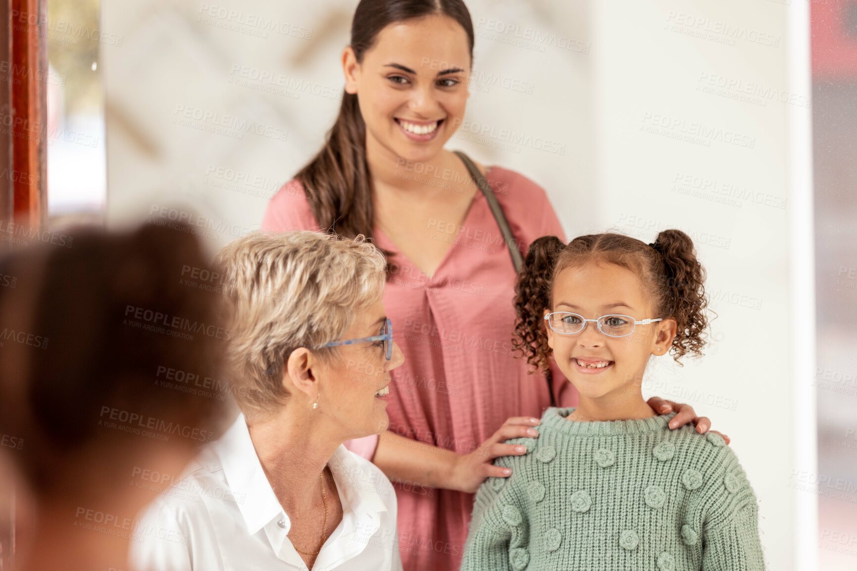 Buy stock photo Mirror, vision and girl trying on glasses in an optical store with her mother and senior optometrist. Happy, smile and child choosing a eyewear frame for her prescription lens in a optics clinic.