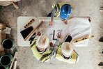 Architect, construction and blueprint with an engineer and designer team working on a building site from above. Meeting, planning and architecture with a design group in collaboration on a project