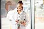 Healthcare, doctor and black woman with tablet in hospital looking at diagnosis, report and online. Technology, innovation in medical care and woman standing in clinic with digital notebook in hand