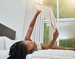 Kid reading story book in bed, relax and enjoy fairytale for entertainment, child development and literature. Story time, youth life growth and learning black girl read cartoon books in bedroom 