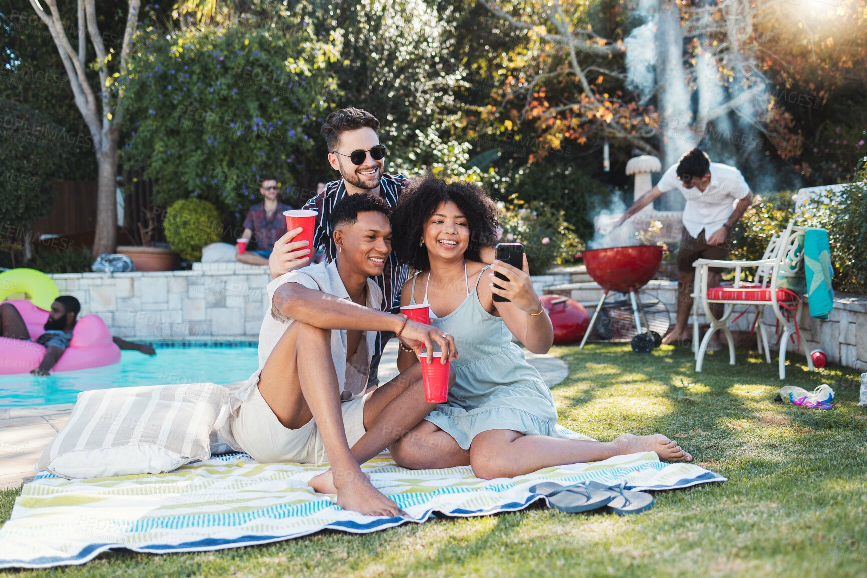 Buy stock photo Friends, party and picnic in summer, selfie and fun together for break, relax and smile outdoor, playful or bonding. Young people, men or woman with smartphone, share picture or celebration in garden