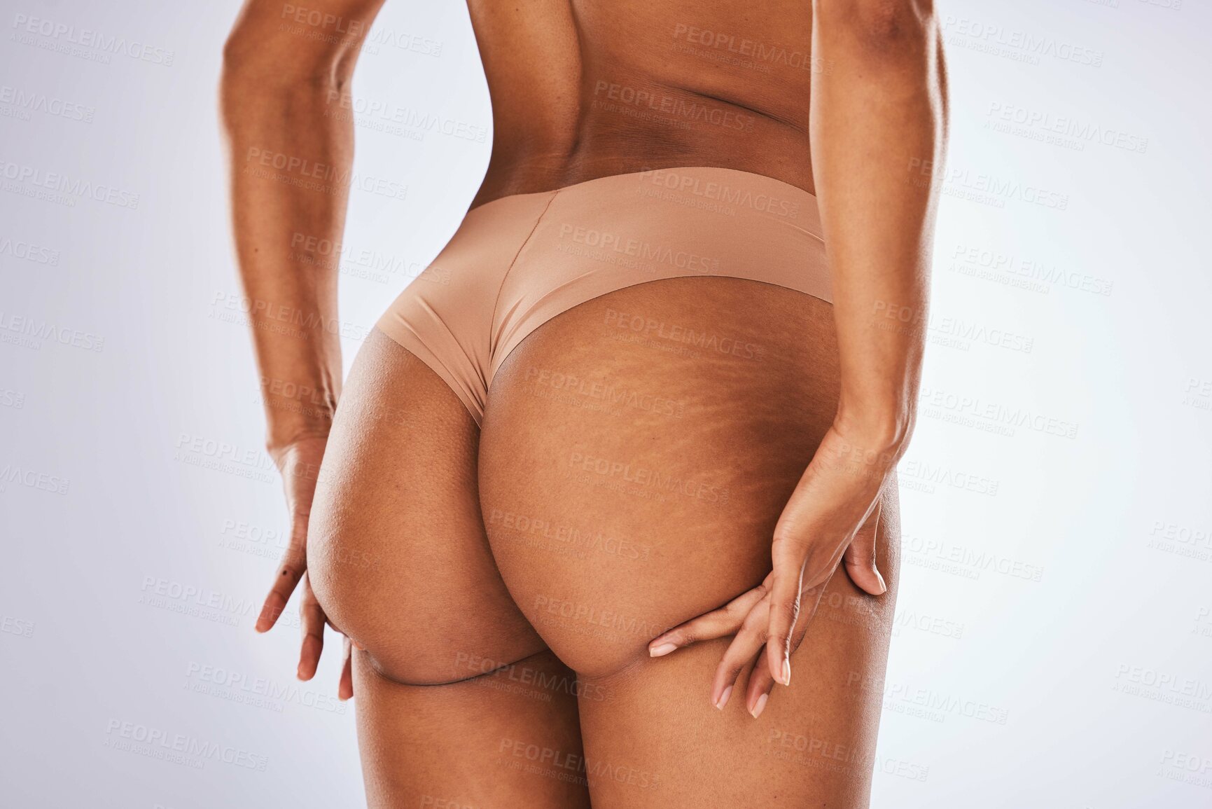 Buy stock photo Cellulite, butt and underwear with a model black woman in studio on a gray background for body positivity. Stretch marks, real and natural buttocks with a female posing in lingerie from the back