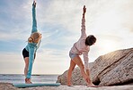 Yoga, mindfulness and woman friends stretching on the beach together for mental health or wellness in summer. Exercise, diversity or nature with a female yogi and friend practicing pilates outside