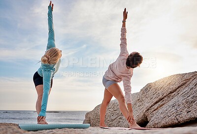 Buy stock photo Yoga, mindfulness and woman friends stretching on the beach together for mental health or wellness in summer. Exercise, diversity or nature with a female yogi and friend practicing pilates outside