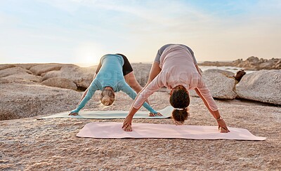 Buy stock photo Women, yoga or stretching on beach mat for relax training, workout or exercise for healthcare wellness, muscle relief or flexibility. Friends, yogi or pilates people on rock for zen fitness at sunset
