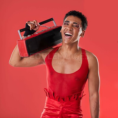 Buy stock photo Happy, man and boombox radio in studio for gay, pride and vogue aesthetic with retro 80s tech by red background. Lgbtq model, vintage fashion and music with happiness, listening and comic laughing
