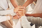 Business women, hands together and unity above in partnership or trust for teamwork, collaboration or support at office. Woman group piling hand in team building for cooperation, motivation or union