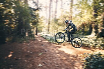 Buy stock photo Cycling, jump and fast with man in nature for adventure, fitness and extreme sports. Workout, exercise and speed with male cyclist on bike in forest park for action, performance and training