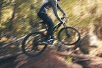Cycling, sport motion blur and man on a bicycle in a dirt forest road doing training and exercise. Biker, outdoor trail and athlete with cardio and energy on adventure for fitness on path