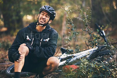 Buy stock photo Forest, cycling and Asian man with knee pain, training and muscle tension in nature, emergency and accident. Male rider, athlete or person with bicycle, leg injury and outdoor for practice and strain