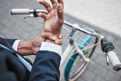 Buy stock photo Wrist pain, hands and city business person with anatomy injury, hurt bone fracture and on urban bike travel. Trauma accident, morning bicycle commute and closeup worker with arthritis risk emergency