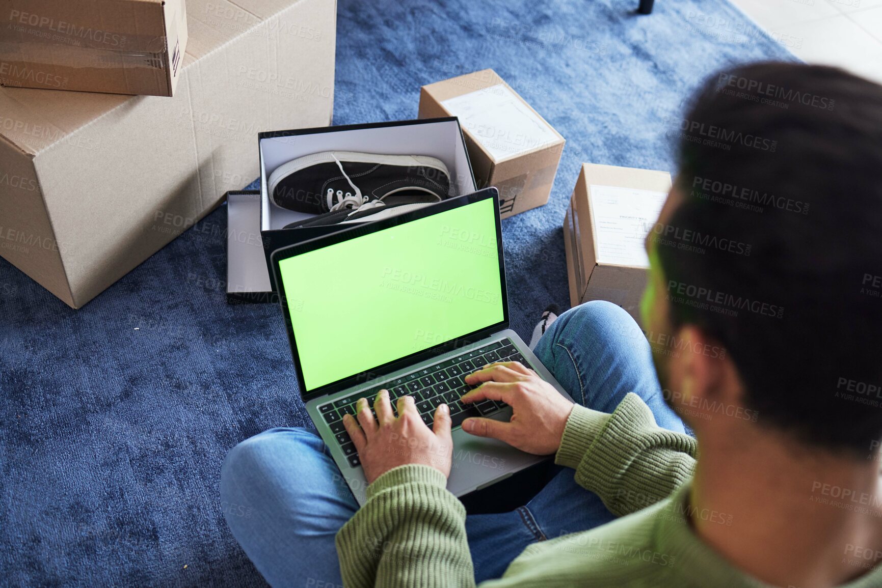 Buy stock photo Ecommerce, man with computer, green screen and box on carpet, shoes and delivery service on digital app. Sale, discount and online shopping on fashion retail brand website, internet search on laptop.