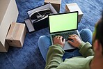 Online shopping, man with laptop, green screen and package on floor, shoes and delivery service on digital app. Sale, discount and ecommerce on fashion retail website, internet search on computer.