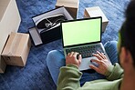 Green screen, man with laptop, online shopping and box on floor, shoes and delivery service on digital app. Sale, discount and ecommerce on fashion retail brand website, internet search on computer.